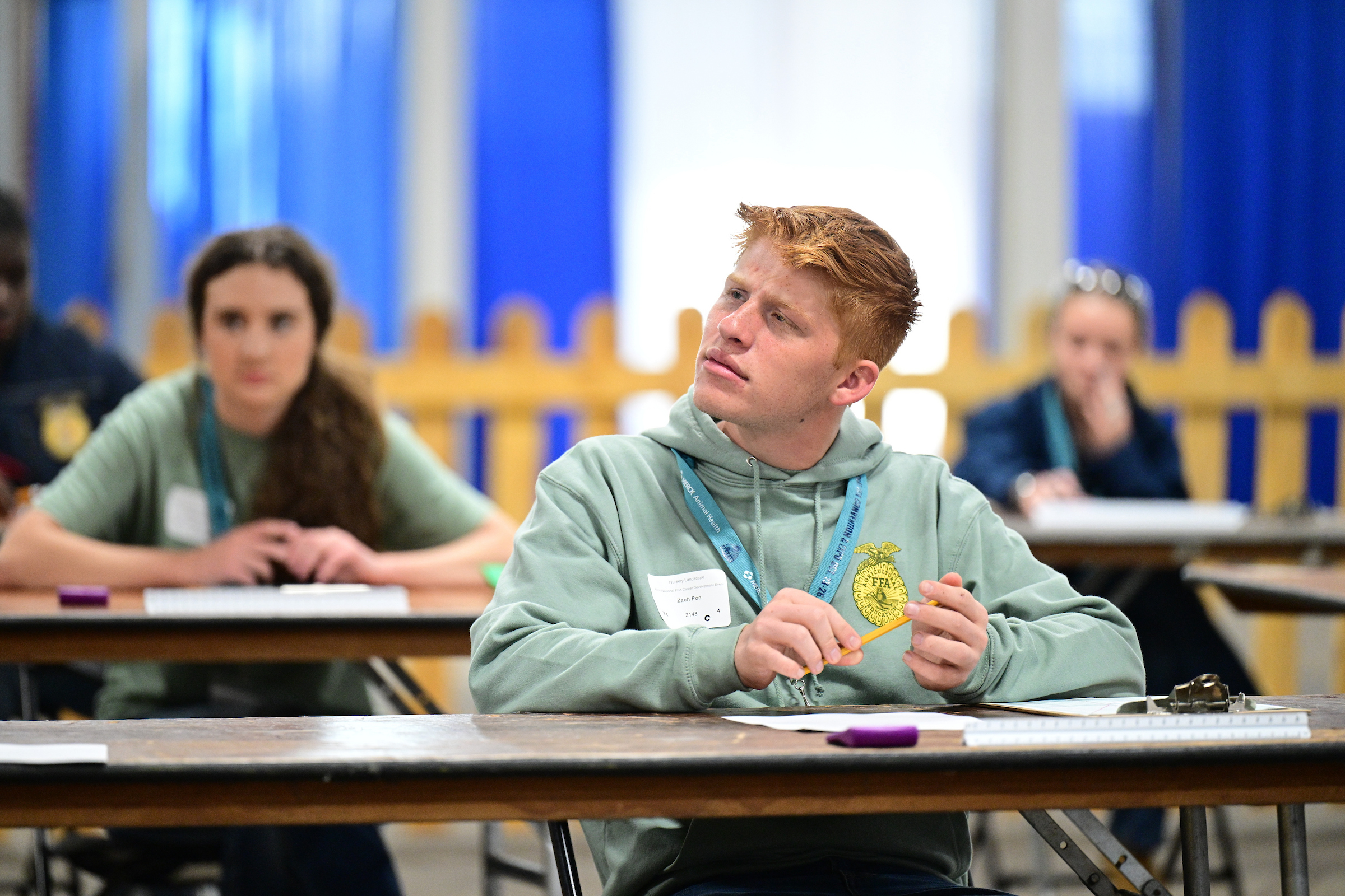 NFL: Miami Dolphins en Indianapolis Colts Student in an FFA tshirt looking engaged in classroom activity.